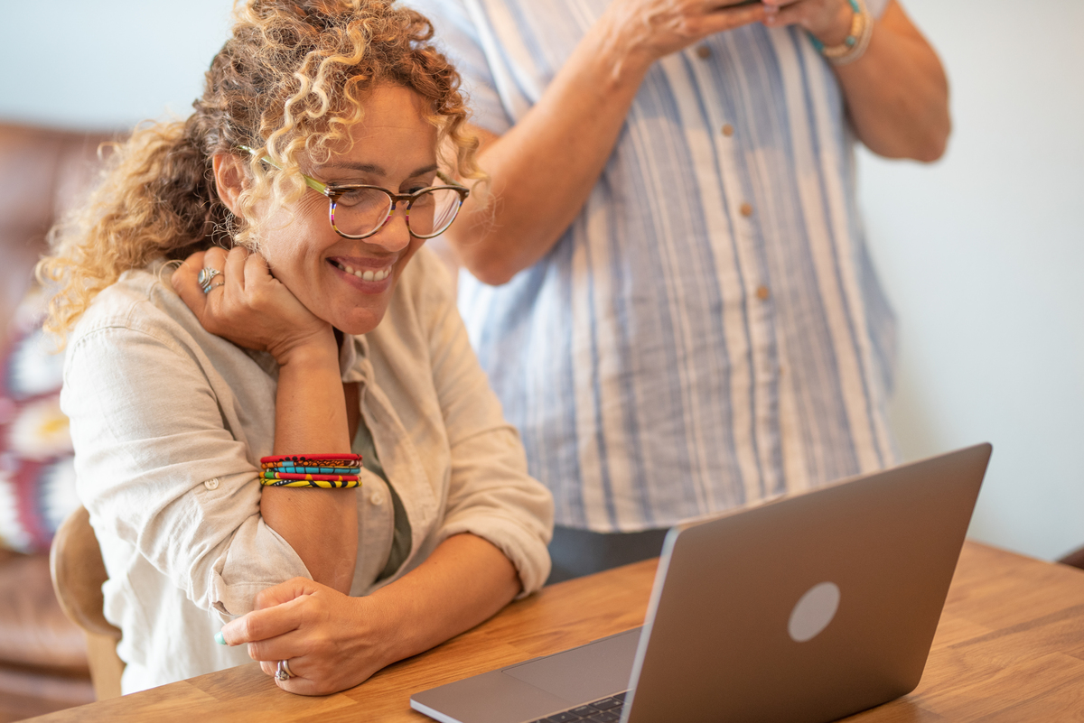 woman smiling at a laptop