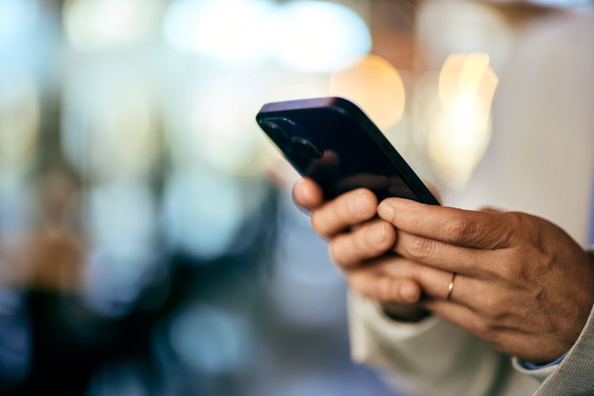closeup of womans hands holding cell phone