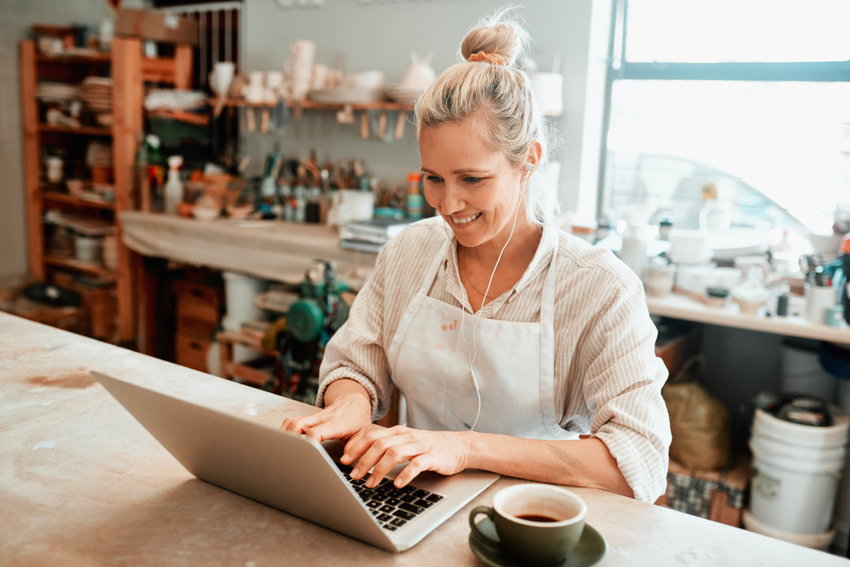 business owner using her laptop in her shop