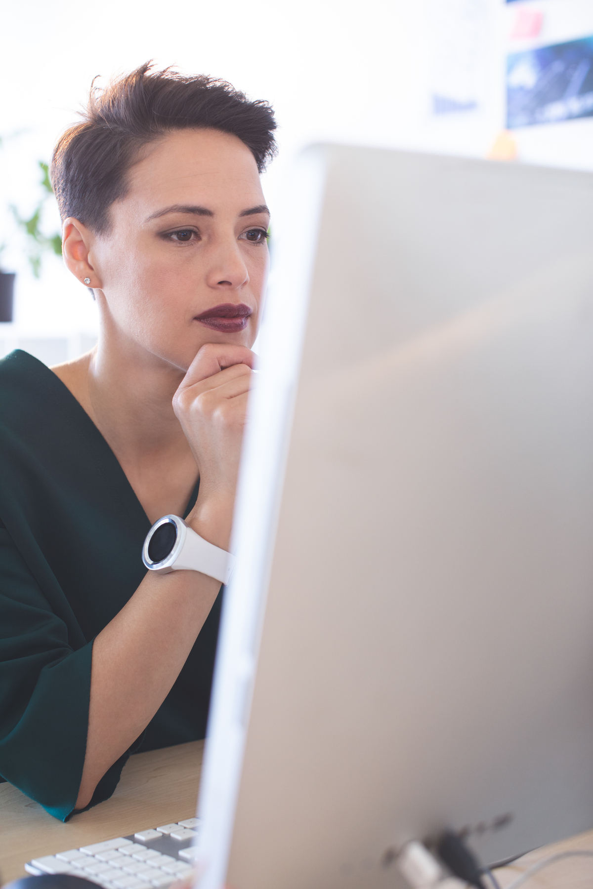 woman looking at a computer screen thoughtfully