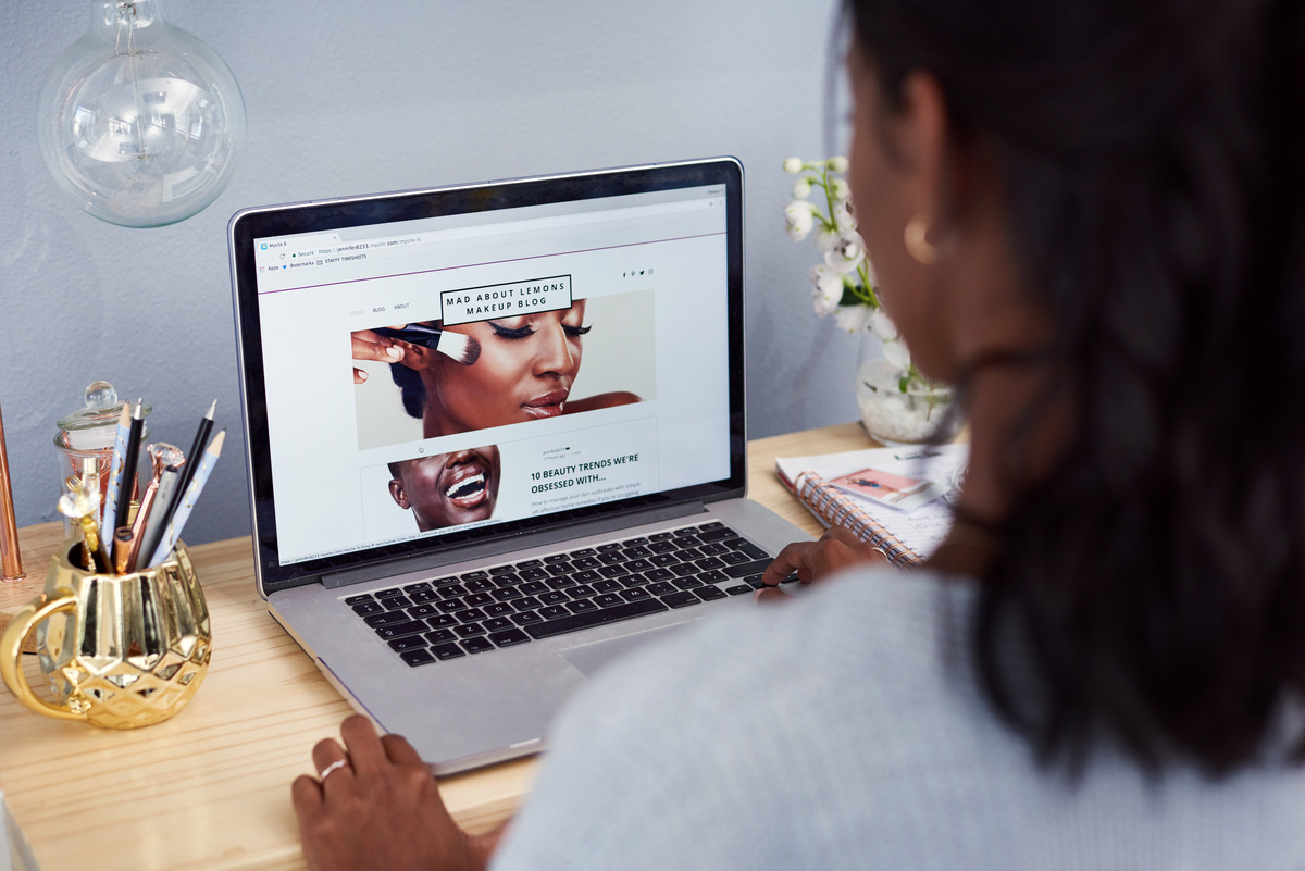 woman browsing on her laptop at a desk